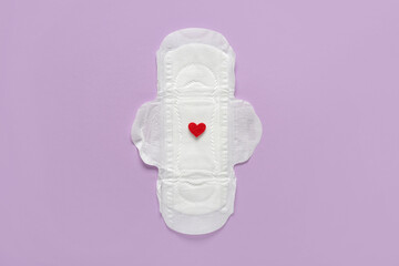 Menstrual pad with red heart on purple background