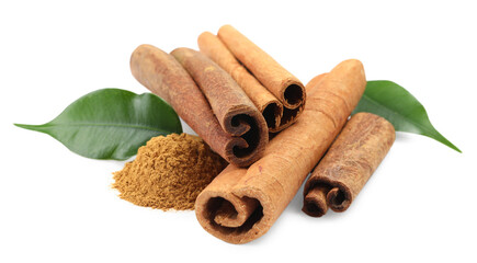 Dry aromatic cinnamon sticks, powder and green leaves isolated on white