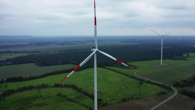 Close up of wind turbine. Aerial voew of wind mills farm park.