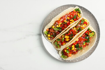 Tasty tacos with vegetables on white marble table, top view. Space for text