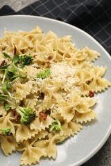 Vegetarian meal. Tasty pasta with fresh vegetables and cheese on table, closeup