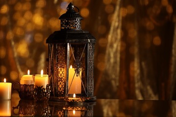 Arabic lantern and burning candles on mirror surface against blurred lights, space for text