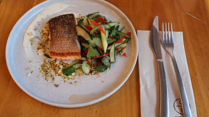 Salmon with green vegetables on the white plate 