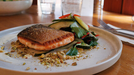 Salmon with green vegetables on the white plate 