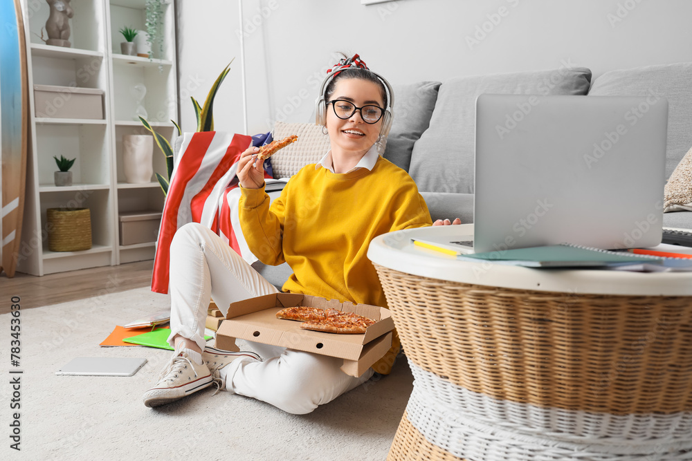 Sticker female student in headphones with pizza using laptop at home