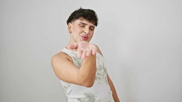 Cheerful young man wearing sleeveless t-shirt, standing isolated on white background, blowing a cute love-kiss into the air - sexy and confident expression caught on camera!