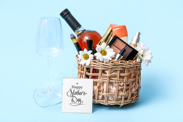 Gift basket with decorative cosmetics, bottle of wine and glass for Mother's Day celebration on...