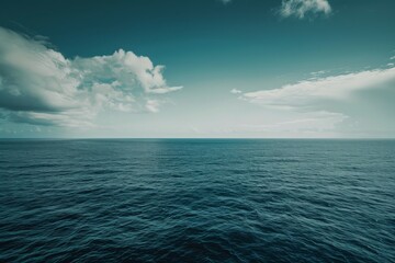 Obraz premium Ocean horizon with calm blue waters under a serene sky, ideal for tranquil nature backgrounds.