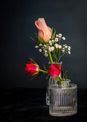 Peach rose bud in petite vase.