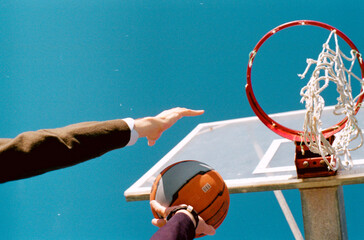 two players hand playing basketball