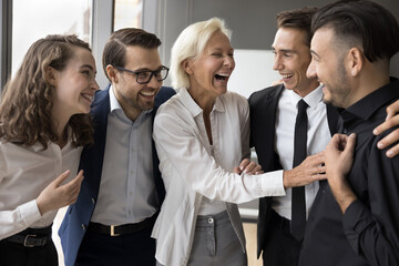 Five diverse enthusiastic employees, group of excited colleagues celebrate successful project...