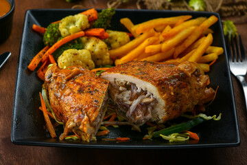 Chicken breast stuffed with edible mushroom and mozzarella cheese in special homemade brown sauce along with French fries and boiled vegetables.