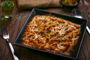 Chicken baked cheese pasta; freshly cooked pasta prepared in special pink sauce with chicken and...