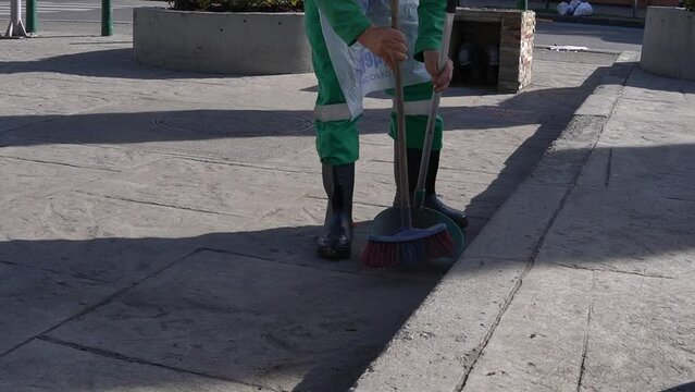 a sweeper collecting dry leaves and garbage found in a park