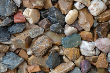 Colorful abstract pebble background. Beach made of colorful stones.
