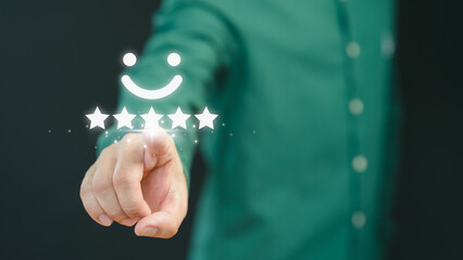 Customer hand touching the virtual screen on happy smile face icon to give satisfaction in service. Concept of assessment testimonial customer service and feedback, Opinion rating very impressed. - obrazy, fototapety, plakaty