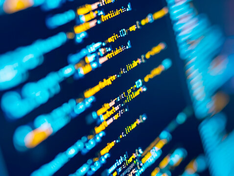Close-up of programming code on a computer screen, with a focus effect, on a dark blue background, concept of software development. Generative AI