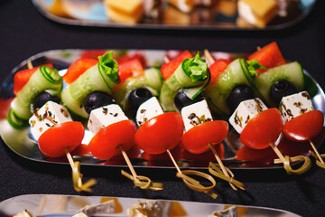 Assorted canapes on metal trays. Delicious appetizers for a buffet. 