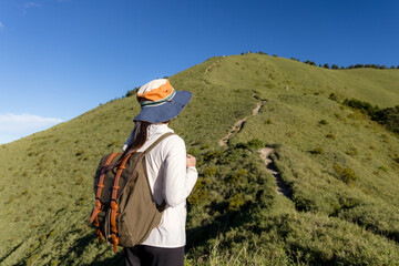Hiking woman enjoy the beautiful view at mountain peak