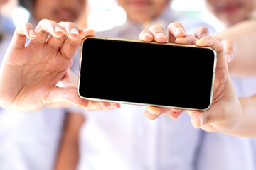 Girls' hands holding a smartphone together Blank black screen