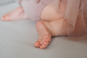 Cute little bare feet of baby girl. Care for baby's delicate skin.