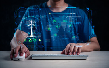 Individual with a computer analyzes wind turbine data on a global digital interface.Clean energy on a holographic display. - 783506855