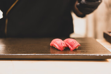 Sushi with tuna and chef background. Japanese Omakase Style