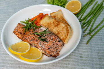Salmon Steak with Butter Toast Ready to eat on a wooden table.