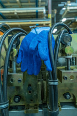 Blue safety protection gloves in factory workshop