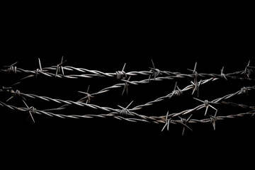 Close up of barb wire isolated on black background 