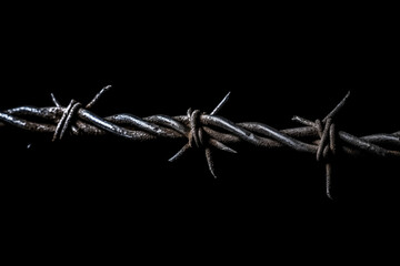 Close up of barb wire isolated on black background 