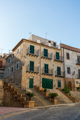Fototapeta na wymiar Pietraperzia, Sicily, Italy. House with cones on the balconies. Summer sunny day