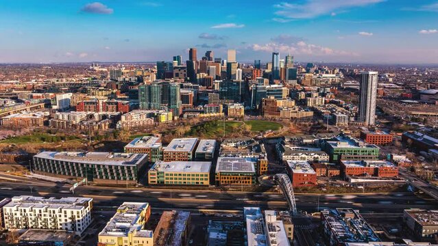 Flying up above Denver skyline on a sunny day, golden hour, aerial hyperlapse, Denver Colorado, 4K