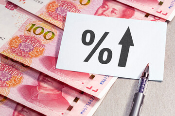 up arrow, interest rates, inflation, economy, finance, crisis and banking and cash yuan banknotes.