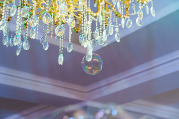 A soap bubble at a crystal ceiling lamp.