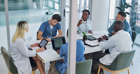Medical, group and meeting for healthcare in conference room with technology, top view and...