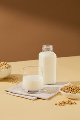 Front view with glass and blank bottle of fresh milk on polka dots white blanket. Advertising concept and blank space for text