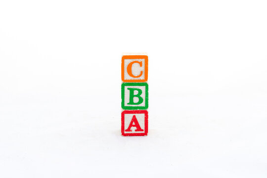 Alphabet blocks C, B and A stacked, and isolated on white background with copy space.