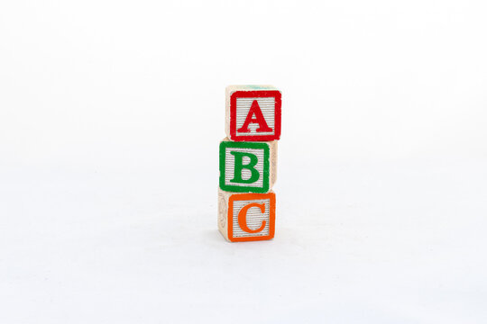 ABC wooden blocks stacked vertically isolated on white background