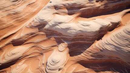 Aerial view of sandstone formations in a desert, with textured patterns carved by wind and water erosion over millennia - obrazy, fototapety, plakaty
