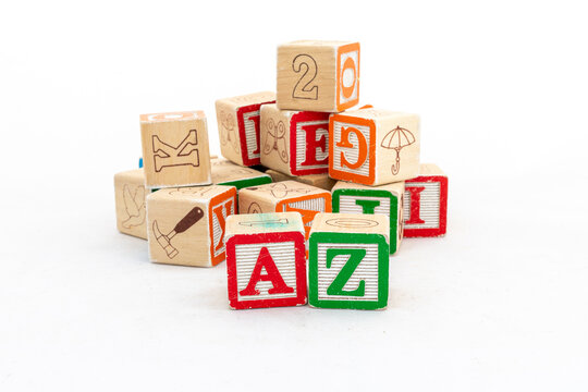 Wooden toy alphabet learning blocks. A and Z alphabets are focused with blurred alphabets background