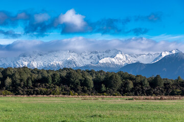 Photograph of the agricultural paddocks and mountain view while driving from Te Anau in Fiordland to Manapouri on the South Island of New Zealand