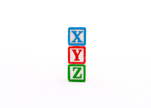 XYZ alphabets letters written on wooden cubes isolated on white background