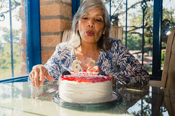 May 12 Mother's Day. Beautiful mother making a very happy wish for her birthday. Cake.
