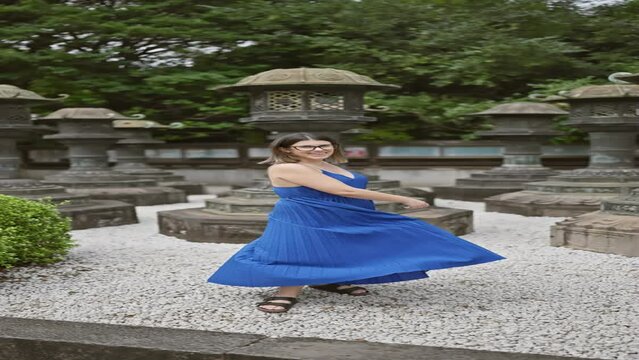 Beautiful hispanic woman with glasses spinning joyfully in her dress around ueno park temple, tokyo. her vibrant spirit dances amidst the urban setting, capturing japan's uniqueness.