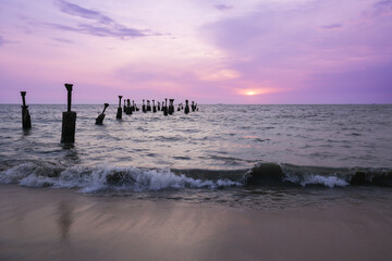 Old ruined sea piers in Calicut Kozhikode beach in Kerala India. Silhouettes of sea piers during...