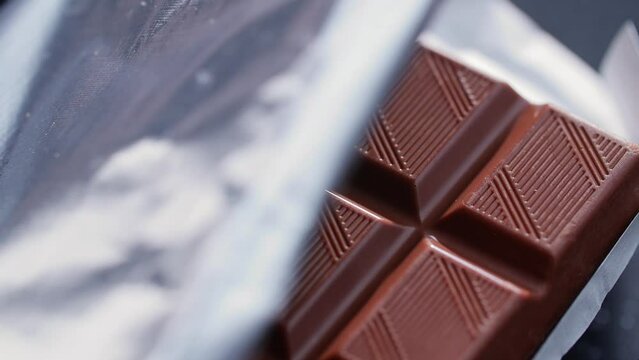 The foil wrapper opens and there is chocolate inside the package. High quality 4k footage