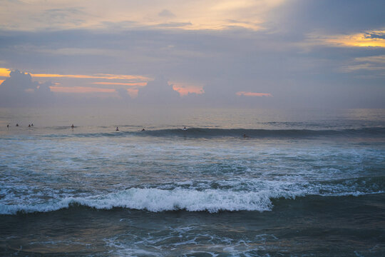 surfers waiting for a wave, in the sea, surf, sky