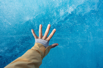Girl's Hand Touching Cold Blue Ice berg in Iceland Winter Glacier - obrazy, fototapety, plakaty
