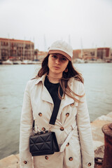 Young girl looking at camera next to a fishing port